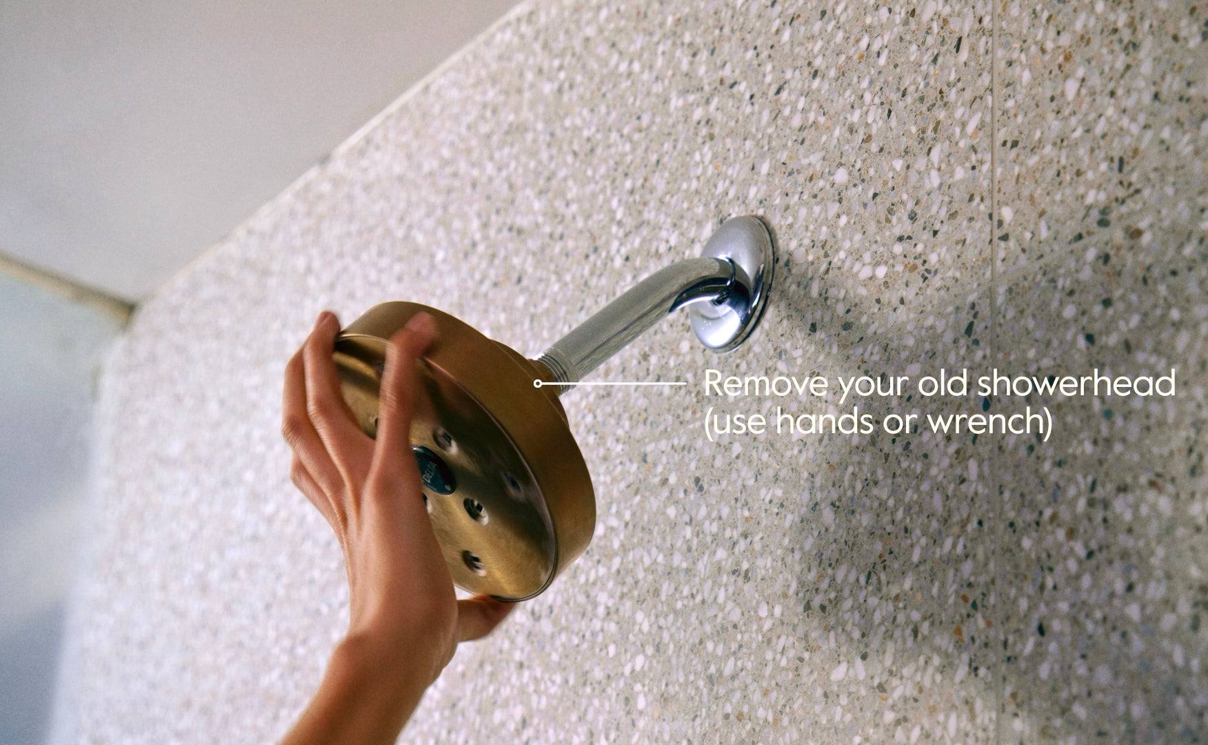 A person changing an old shower head