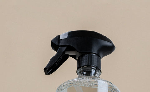 A bottle of vinegar used to remove a shower head